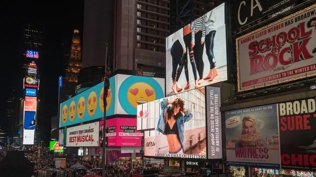 Photo of billboards in a big city showing subliminal messaging
