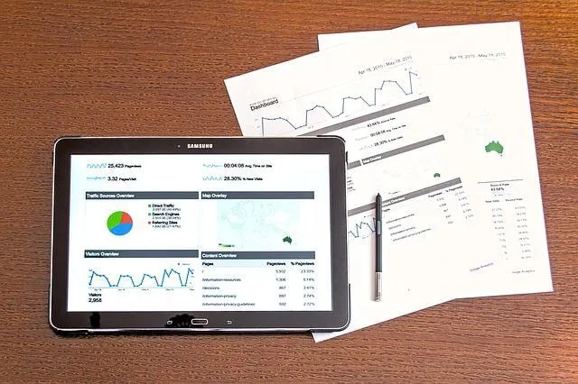 Google Analytics on a tablet screen with printouts of data