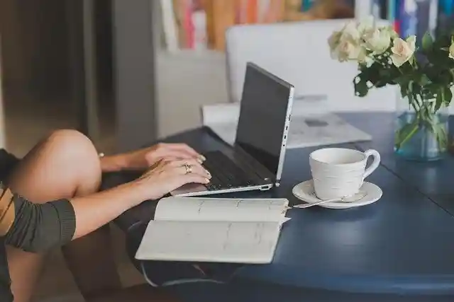Person typing on a laptop at a table