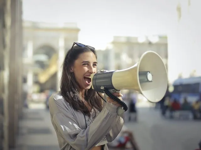Mujer con un megáfono al aire libre 