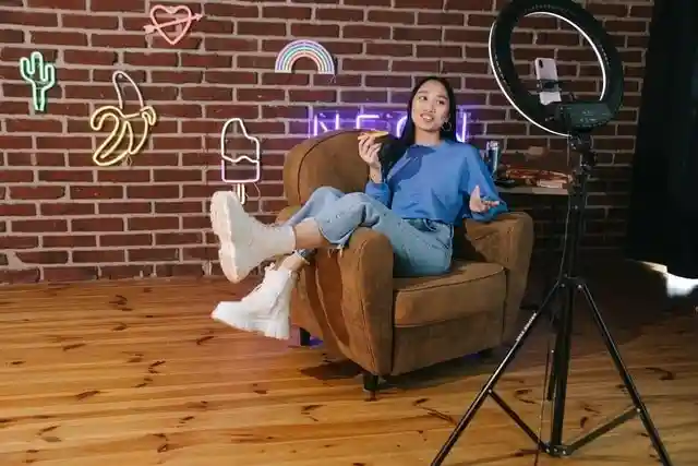 Woman recording a YouTube video with a set and lighting 