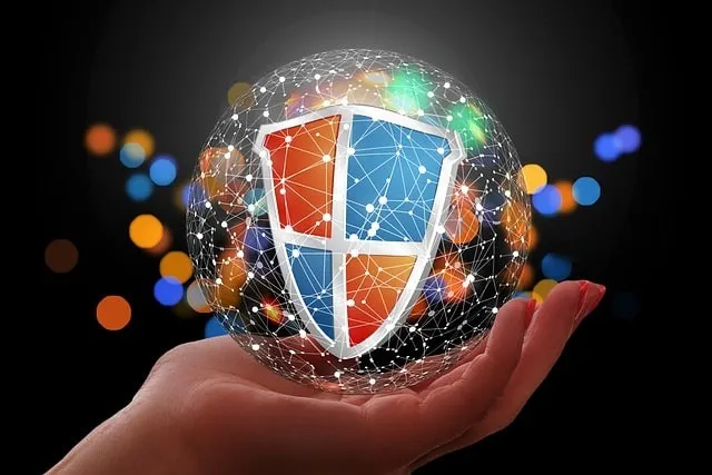 Hand holding a security graphic logo (data protection)