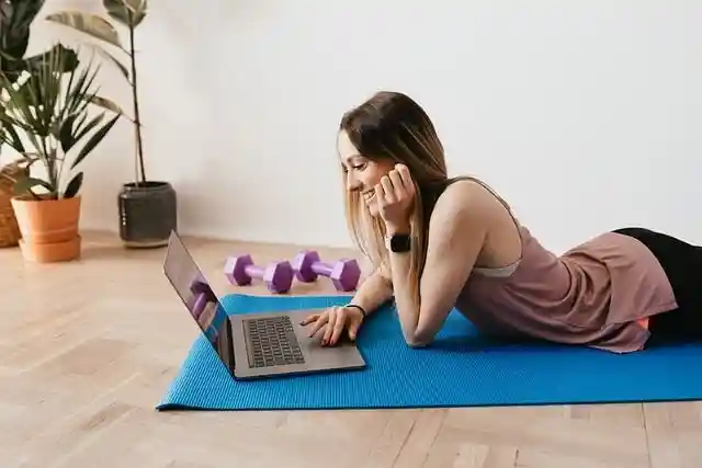 Online-Fitness-Trainer arbeitet am Laptop