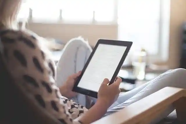 Woman reading an ebook on an ereader or Amazon Kindle