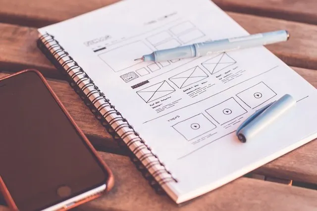 Wireframe markup for a website design in a notebook
